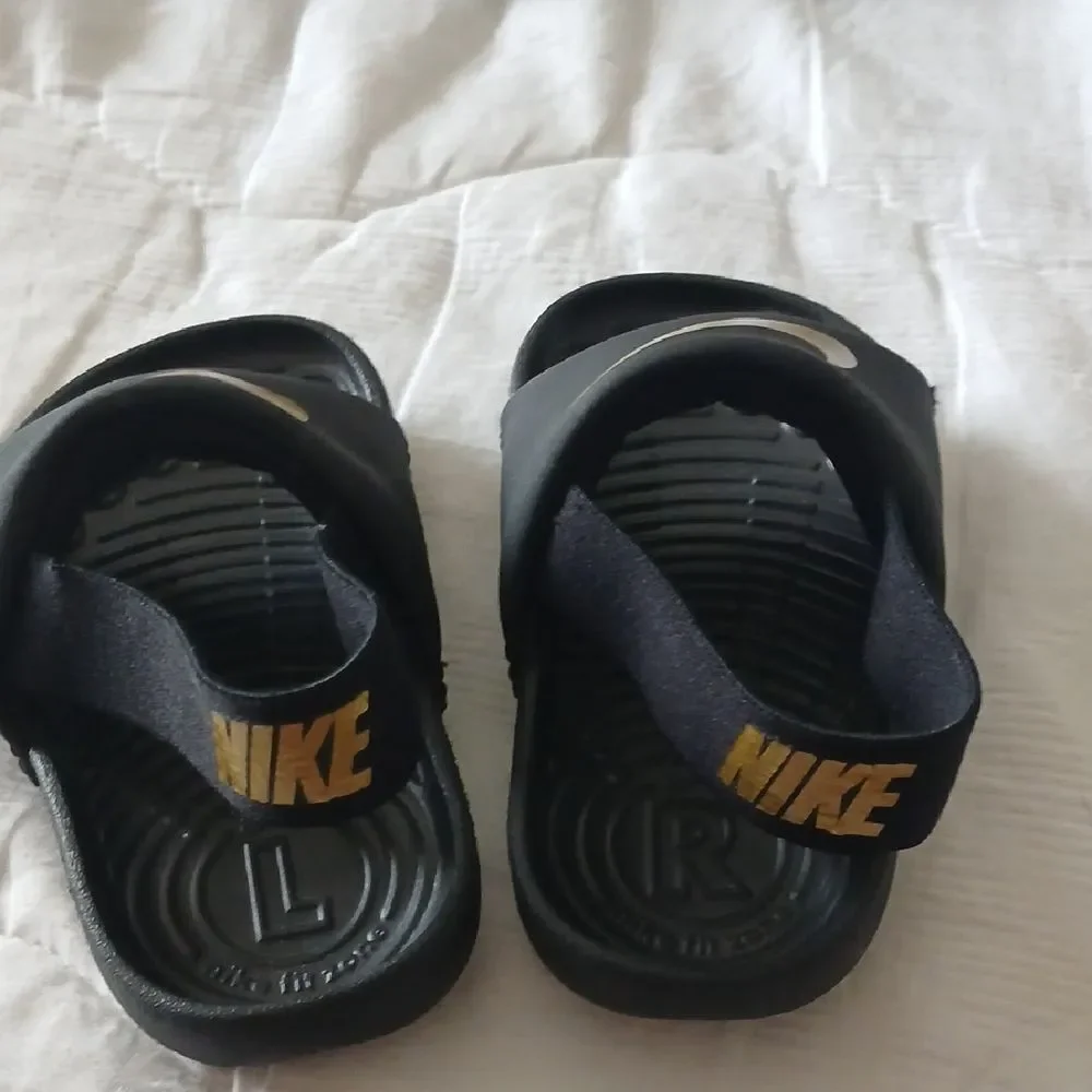 Nike Black and Gold Slide Sandals with Textured Footbed